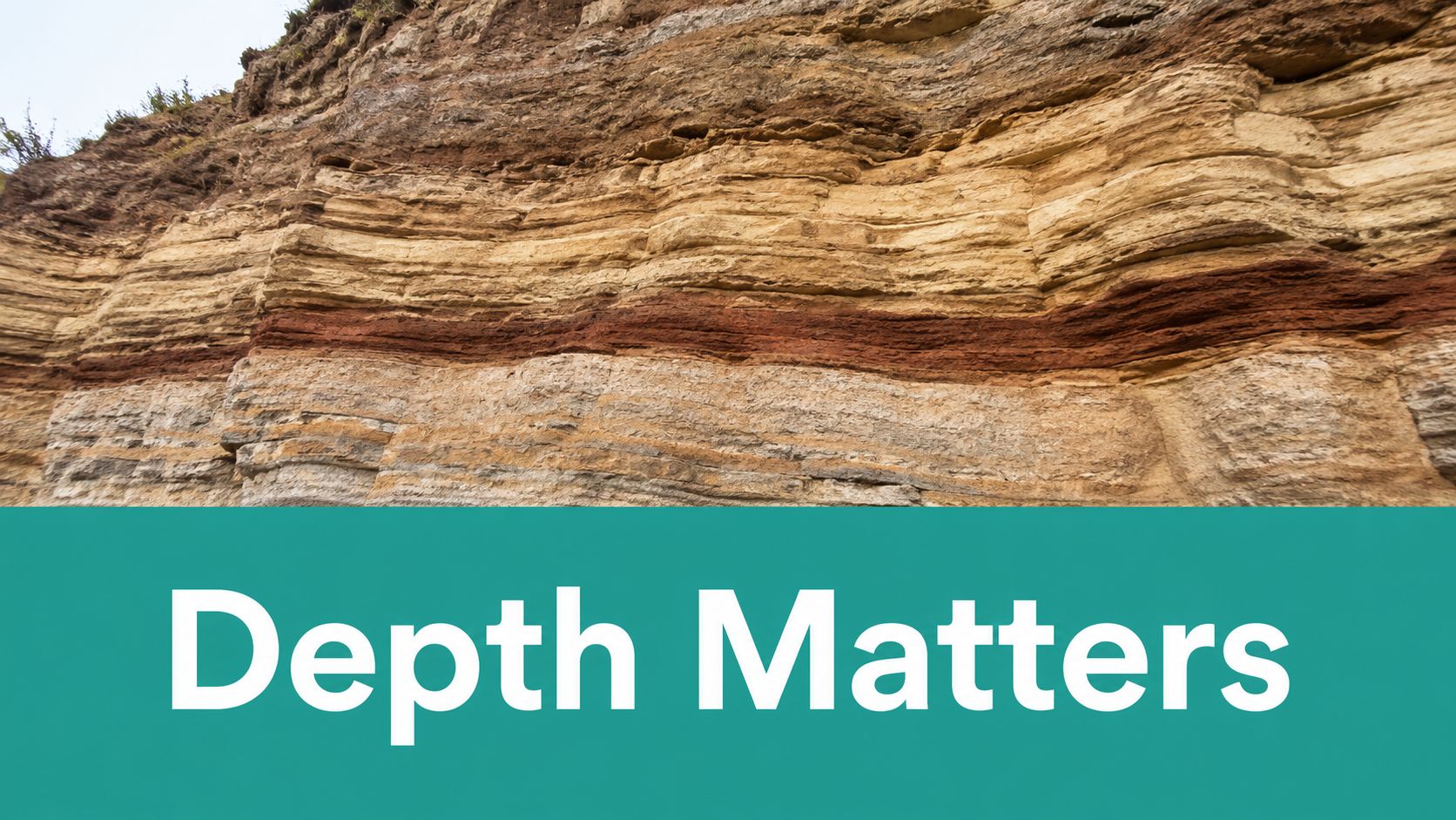 A close-up view of exposed sedimentary rock layers featuring distinct red, beige, and brown geological strata.