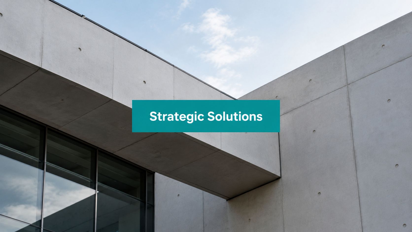 A modern concrete building with a teal banner displaying the text Strategic Solutions.